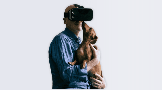 Tim Crouch wearing a VR headset, holding a brown Dachshund